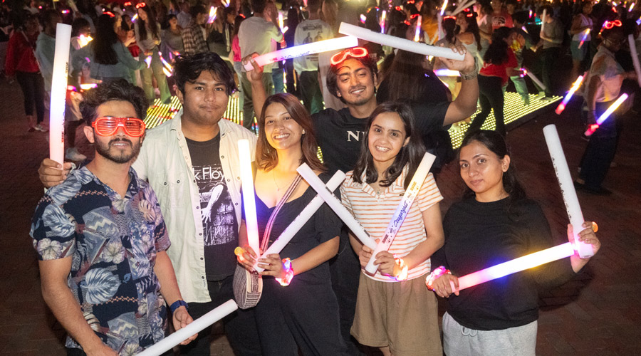 SIUE students at night with glow sticks.