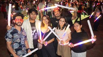 SIUE students at night with glow sticks.