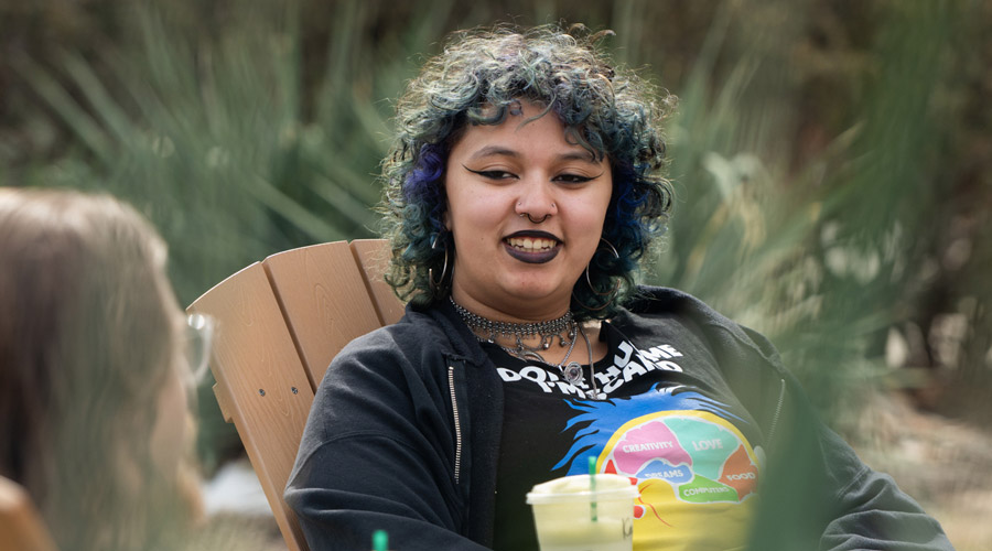 SIUE student sitting on campus.