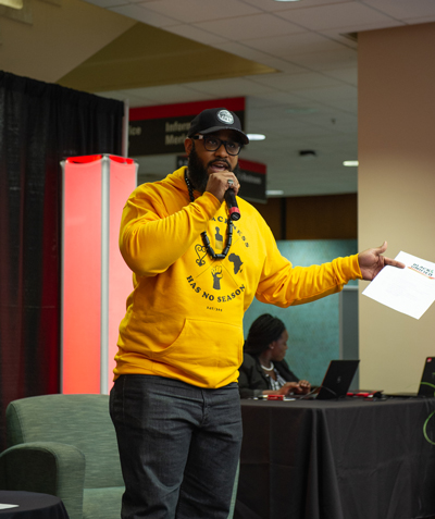 A man with a microphone in the Morris University Center at SIUE.