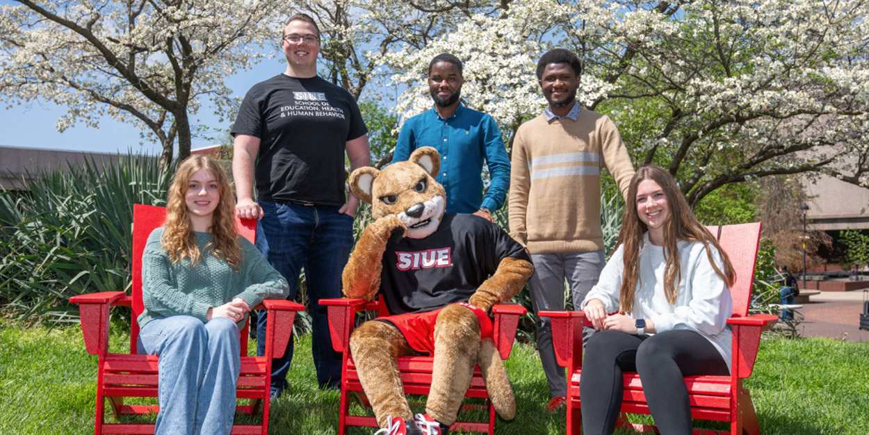 A group of SEHHB students sitting in chairs.