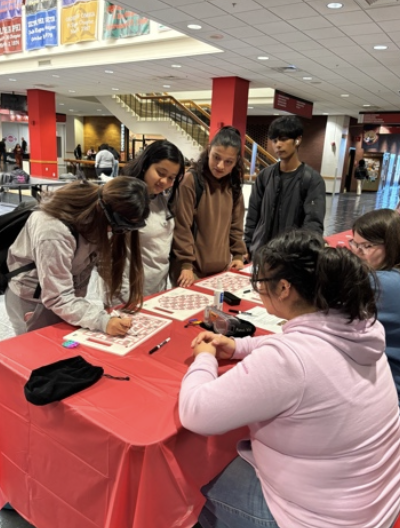 4 students visit EOA table and complete interactive activities with 2 EOA practicum students