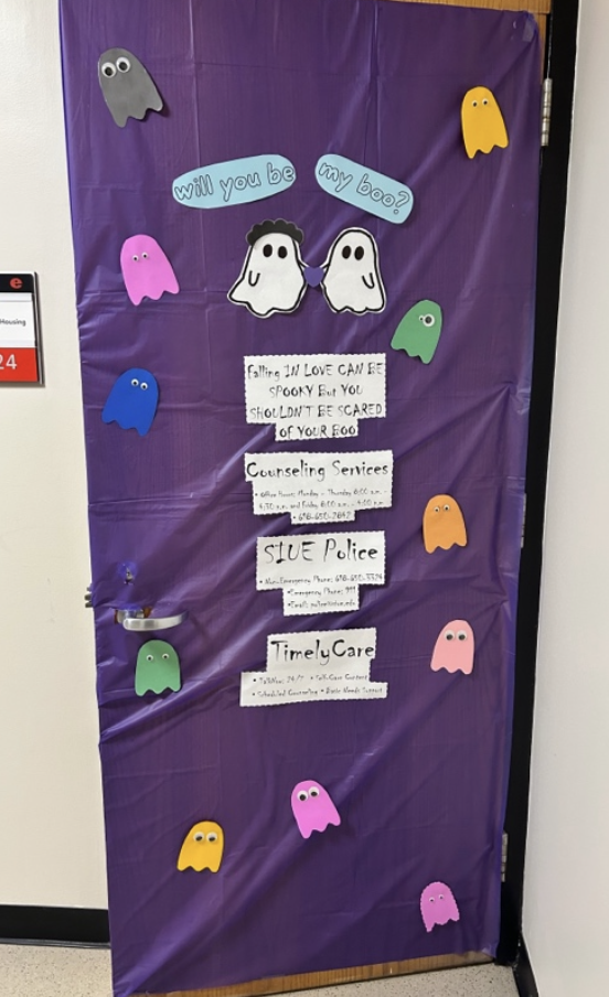 Purple door with multi colored ghosts and domestic violence information