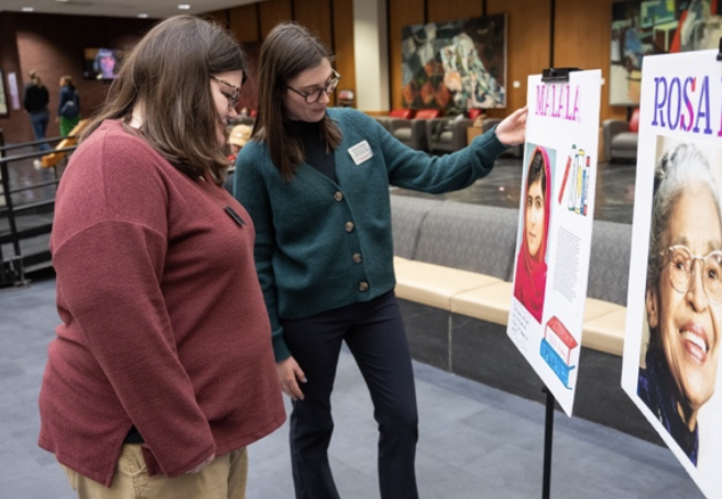 2 students view the Malala poster