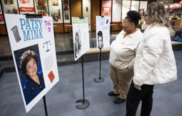 2 students look at the Malala poster