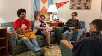 SIUE students in a Cougar Village apartment living room.