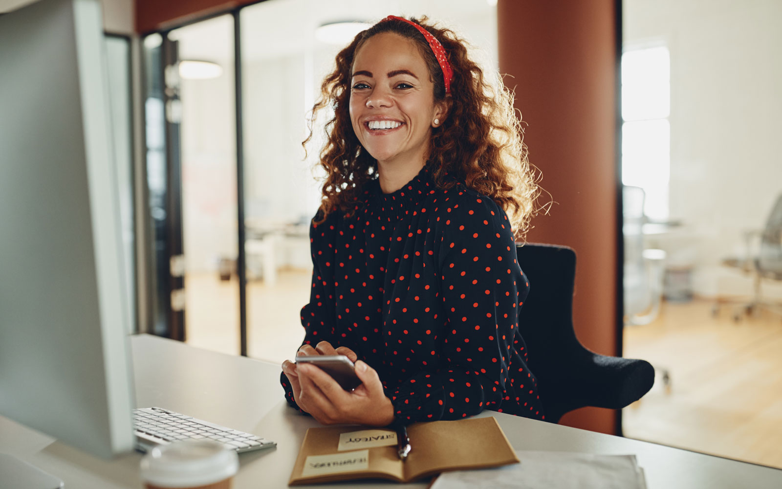 smiling professional woman at desk