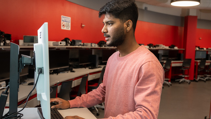 young man working on computer in lab