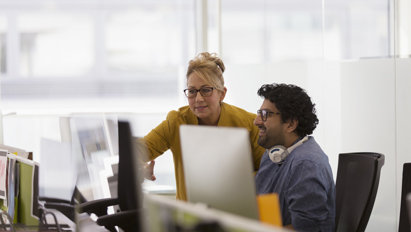 coworkers looking at computer