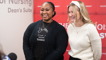 two girls laughing while being interviewed
