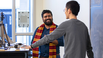 student engaging with professor