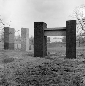 Brick towers constructed to test potential buildings materials framed a nearby metal structure that later became the Quonset Hut theater, home to the Student Experimental Theater Organization.