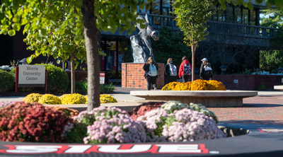 SIUE Campus with flowers in front of the Morris University Center.