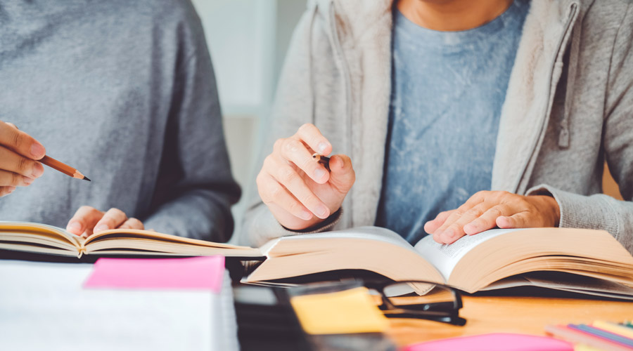 A person writing in a book.