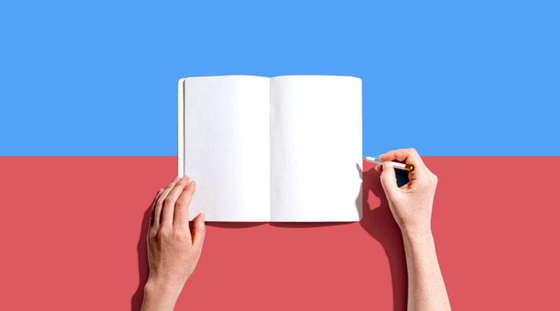 A person opening a blank book.