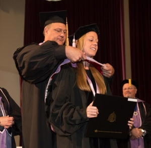Dr. Jennifer Worner is hooded by her father, Dr. Christopher Larsen