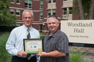 Jerry Bartley of USAgain presents Mike Schultz, director of University Housing at SIUE, with a plaque celebrating the donation of 2,310 pounds of textiles.