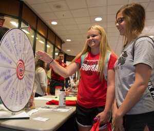 Freshmen students Haily Neisler and Marissa Cesaretti visit the Dance Marathon table.