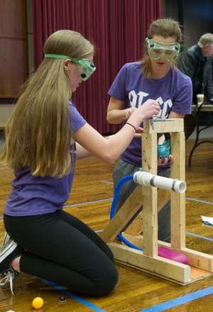Mascoutah High School students Kaitlyn Jennings (L) and Colleen Shehar (R) test their build in the Air Trajectory competition.
