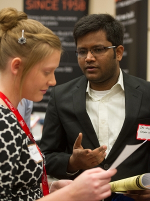 Student Sai Vallapu visit with an employer at the spring career fair