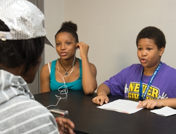 Aanyla Edwards and Nathaniel Brewster learn about the history of East St. Louis during an interview at the Clyde C. Jordan Senior Center.
