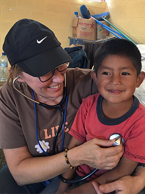 SIUE School of Nursing’s Deborah Horton provides care to a young boy during a medical mission trip in Guatemala.
