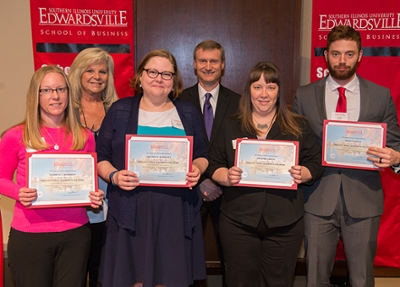 The William E. Baker Memorial Scholarship for Business, sponsored by Sherry Baker (back), who stands next to School of Business Interim Dean Tim Schoenecker, was presented to (Front L-R) Patricia Bourbon, Amanda Endicott, Heather Grieve and Adam Gaxiola. 