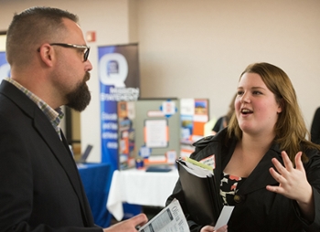 SIUE student Oliva Wernecke, a native of Decatur, speaks with prospective employer Matt Andrews, principal of Dennis Lab School in Decatur.