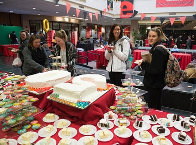 People celebrated with cake and a decades-themed candy bar at the MUC's 50th birthday party.