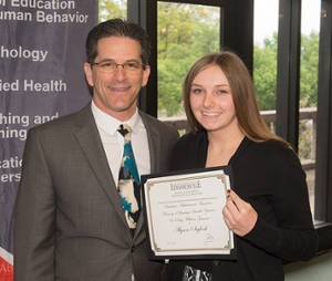 Brighton native Alyson Siglock, a senior majoring in nutrition, earned the award for Academic Achievement in memory of Lindsey Arnold-Zimmer and Riley William Zimmer. She stands with SEHHB Dean Dr. Curt Lox.