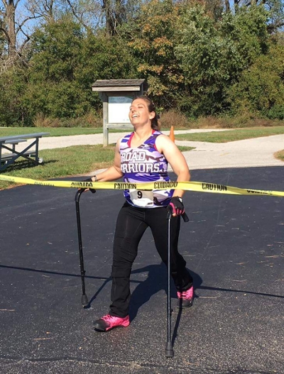SIUE alumna Tiffany Eickhoff is all smiles as she crosses the finish line during her 10K in October, 2016.