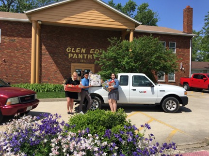 Olivia Lennon, Ivan Solis Cruz and Christine St. Louis deliver food to the Glen Ed Food Pantry.
