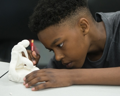 A student works meticulously to create his own trophy.