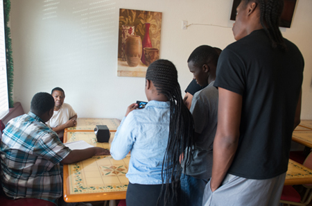 A group of students participating in SIUE’s Digital East St. Louis program record an interview with an employee at Sherry J’s restaurant in East St. Louis. The interview will be part of a documentary they are creating on the topic of soul food.