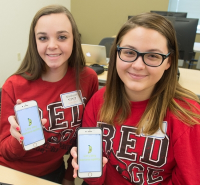 (L-R) Madison Wallace and Anna Miller, sophomores at Alton High School, display the mobile app they created during SIUE’s SheCode event.