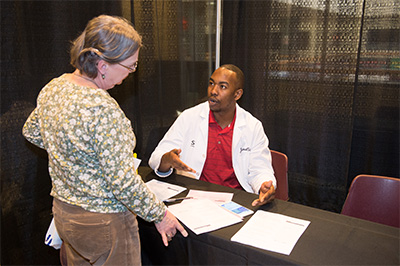 School of Pharmacy student Jamal Sims visits with Cheryl from Highland at SIUE’s 11th annual Free Diabetes Education Program.