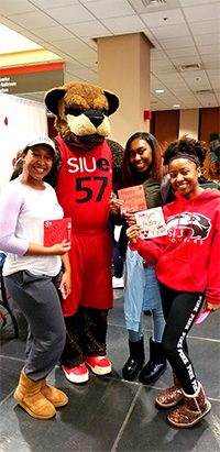 Maree' Slack (left) and friends pose with Eddie the Cougar after he offered them a valentine.