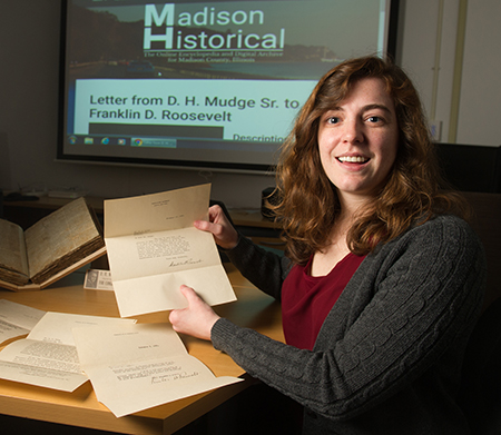 SIUE Graduate Student and Madison Historical Research Assistant Kelli West holds a 1928 letter from Franklin D. Roosevelt to Edwardsville native D. H. Mudge Sr. 