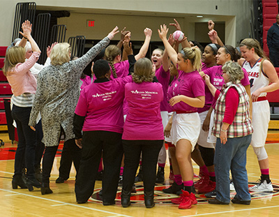 Breast cancer survivors join the SIUE Women's Basketball team at the beginning of Saturday's game. 