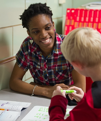 SIUE senior accounting major and Project Advance - America Reads participant Tashawna Nash helps a fourth grade student with a math problem during a tutoring session in South Roxana.