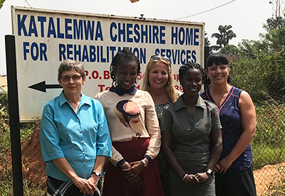 SIUE's Kathy Brady, PhD, (far left) and Michelle Cathorall, DrPH, (far right) stand outside Katalemwa Cheshire Home for Rehabilitation Services in Uganda with social worker Jackie Amassee and director Olive Nabiryo, and Project Restore founder and director Catherine Keck (back middle).