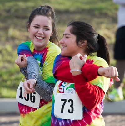 Two runners stretch before the 2017 Decades Dash.