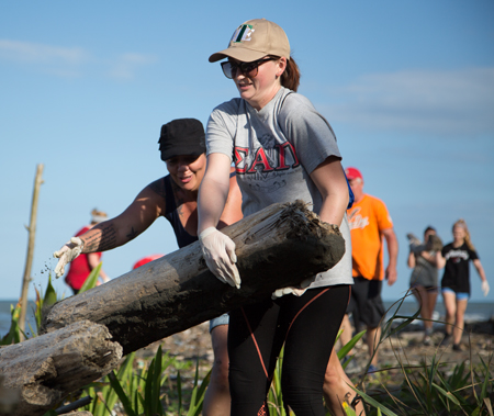 Public Health students help to clear a beach. 