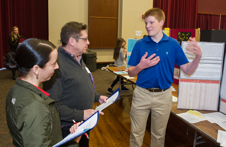 Waterloo High School sophomore Charlie Dake shared details on his communication research project with SIUE Associate Provost for Research and Graduate School Dean Jerry Weinberg, PhD, and Carol Colaninno, PhD, assistant research professor in the SIUE STEM Center.