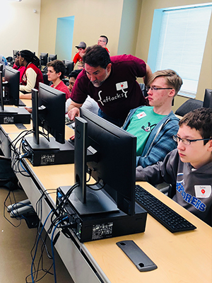 Helping participants during WeCode was Dennis Bouvier, PhD, associate professor of computer science.
