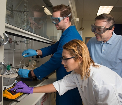 SIUE’s Dr. Yun Lu looks on as Peter Maness and Nasim Salimrafter work in the lab.