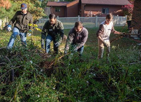A group of students got to work to beautify the yard of a local senior citizen. (L-R) Tristan Cano, Alex Holub, Zane Harris and Micah Burgdorf.