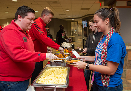 (L-R) SIUE’s Tyler Manning and Jeffrey Waple serve breakfast to Amanda Vanderhaeghen, of Batavia, and Jessica Coats, of Normal.