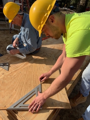 SIUE’s Chris Donovan meticulously measures a piece of plywood on the job site in Florida.