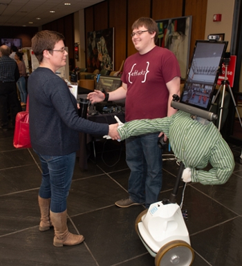 SIUE computer science graduate student Zach Anderson demonstrates the robotic arm on a telepresence robot that can move and mimic a remote user’s movements.